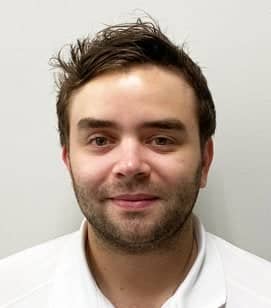 Headshot of Preston Teller. He is a white man with short brown hair wearing a white collared shirt